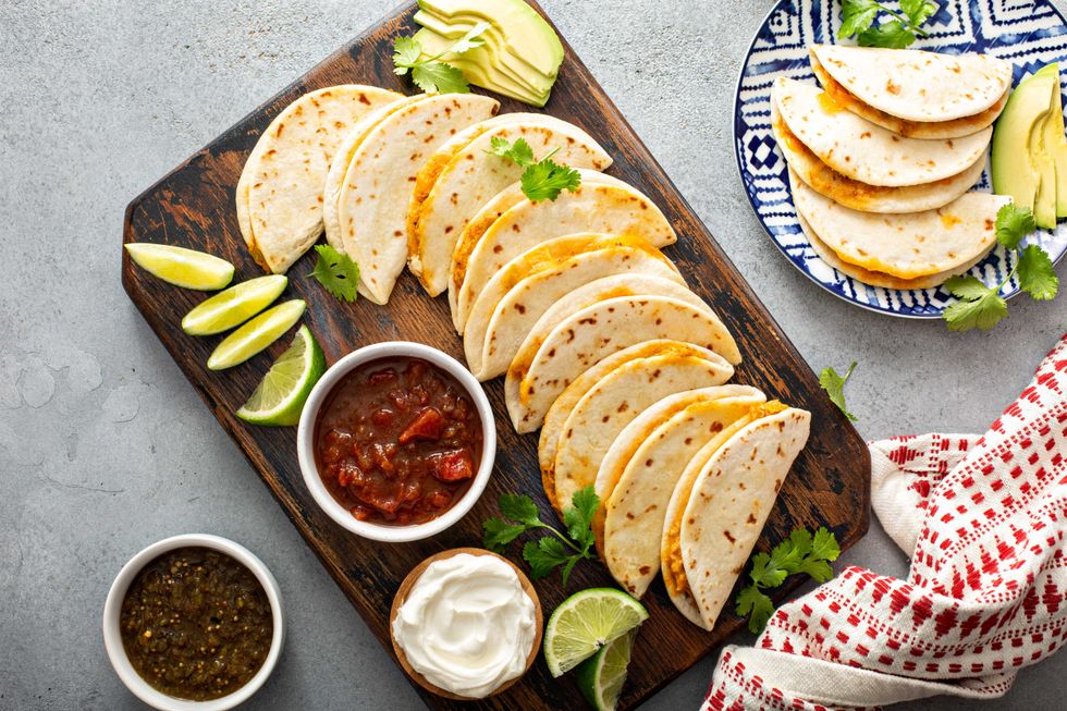 Baked tacos with pulled chicken and cheese served with sour cream and salsa