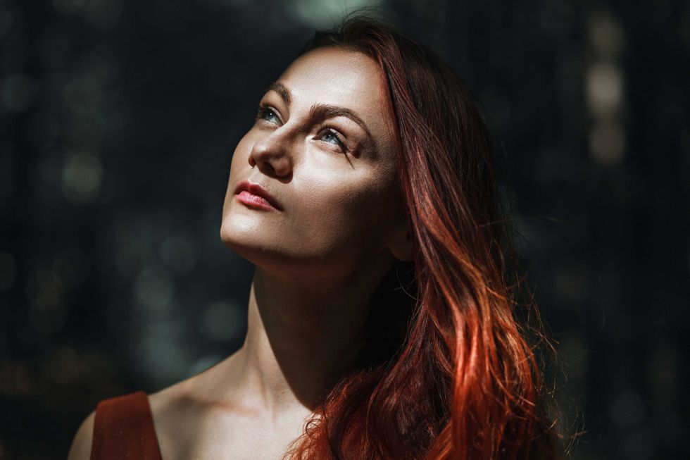 beautiful charming romantic woman with red hair, summer portrait on nature close-up