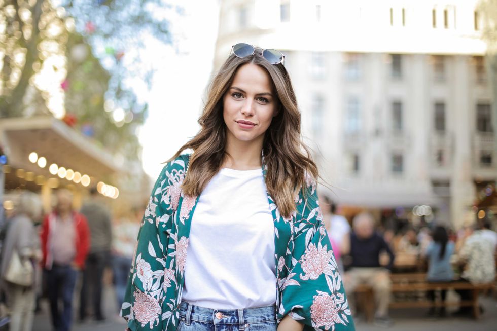 Beautiful smiling girl walking in the city