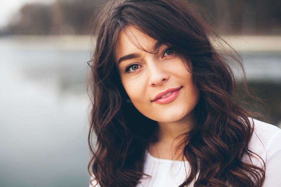 Beautiful smiling plump girl. Closeup portrait of gorgeous woman looking to camera