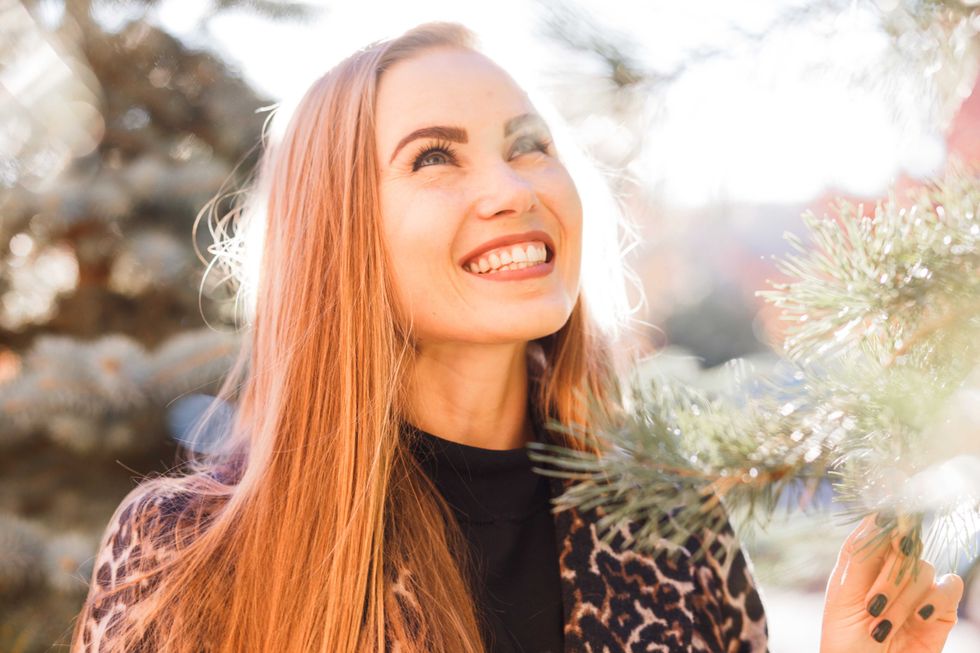 Beautiful stylish woman in the street smiling in sunshine light