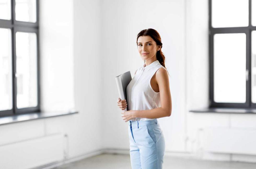 business, people and corporate concept - businesswoman or realtor with folder at office