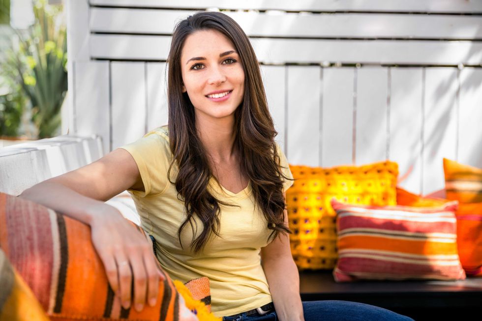 Casual portrait of a pretty woman peaceful and comfortable sitting outside on a bright sunny day