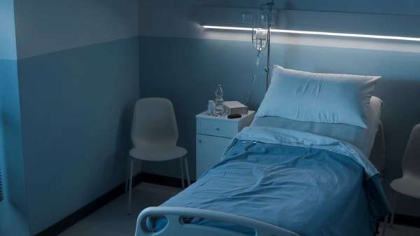 Clean hospital room interior at night with bed and medical equipment, medicine and healthcare concept