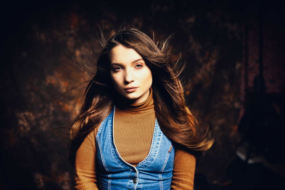 Emotion on the face of a beautiful girl on a canvas backdrops background