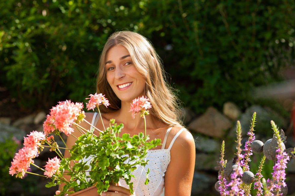 Garden in summer - happy woman with flowers