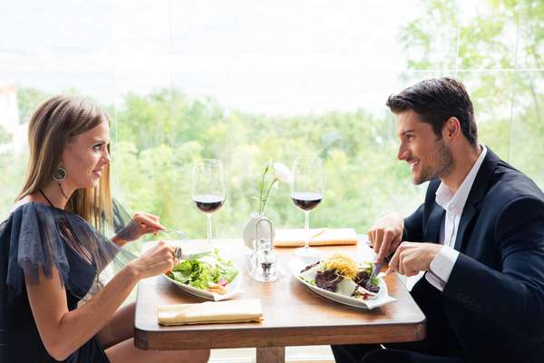 Happy beautiful couple having lunch in restaurant