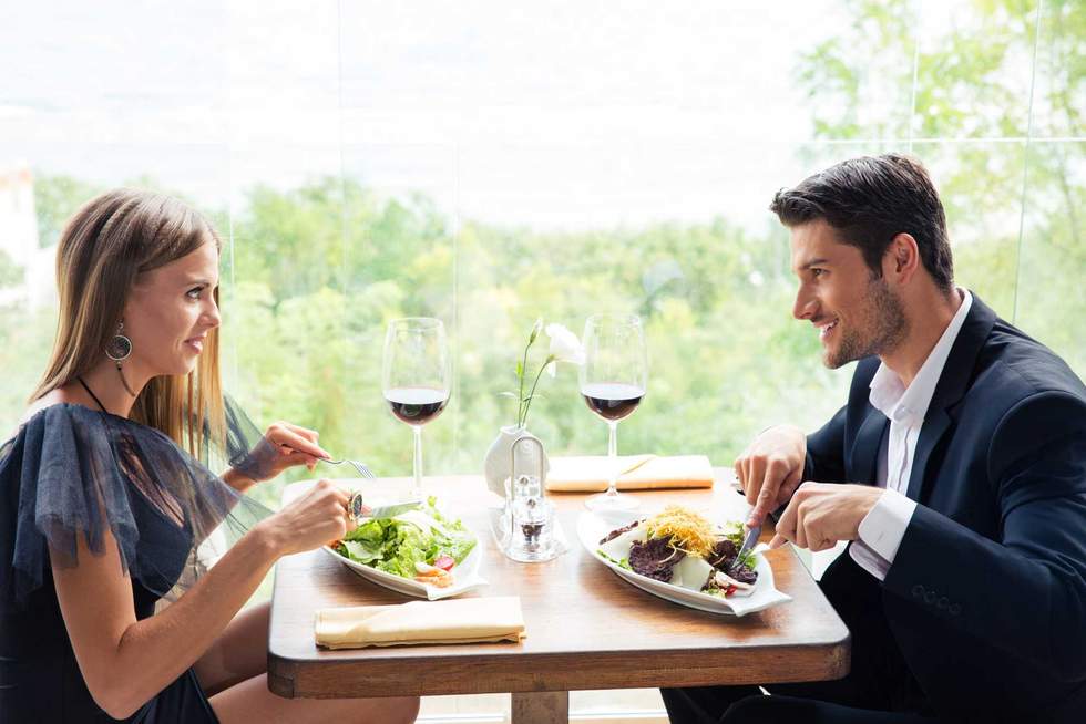 Happy beautiful couple having lunch in restaurant