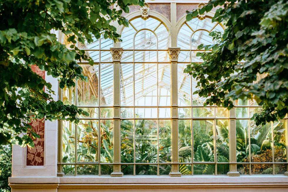 Historic Hivernacle glasshouse exterior with tropical plants in Parc de la Ciutadella, Barcelona
