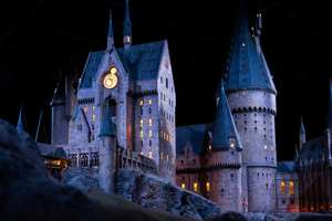 JAPAN - Nov 13, 2023: Closeup night view of Hogwarts Castle's clock tower illuminated beautifully highlighting its magical architecture at Warner Bros. Studio Tour Tokyo, The Making of Harry Potter