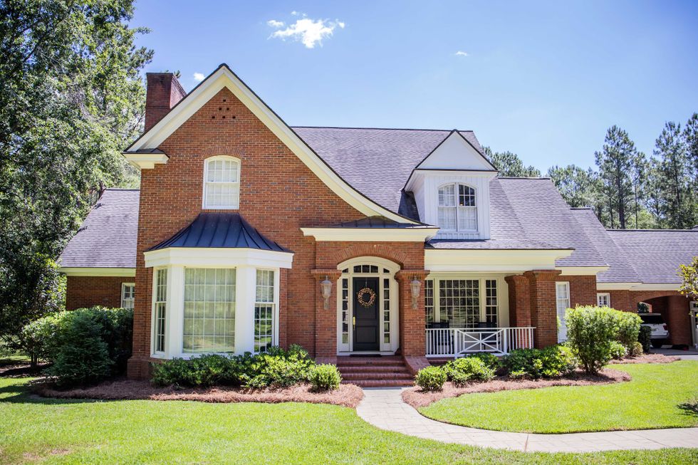Large Red Brick Traditional Colonial Home House on a large Woode