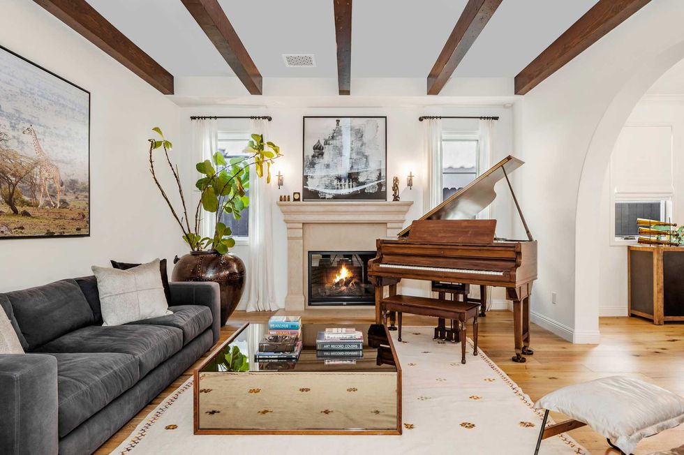 living room with furniture, wood ceiling and art on the wall
