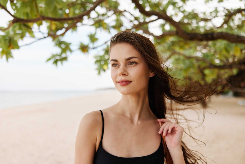 long woman sea ocean copy-space space walking sand nature vacation happy beach copy hair summer water person caucasian girl smile young smiling adult