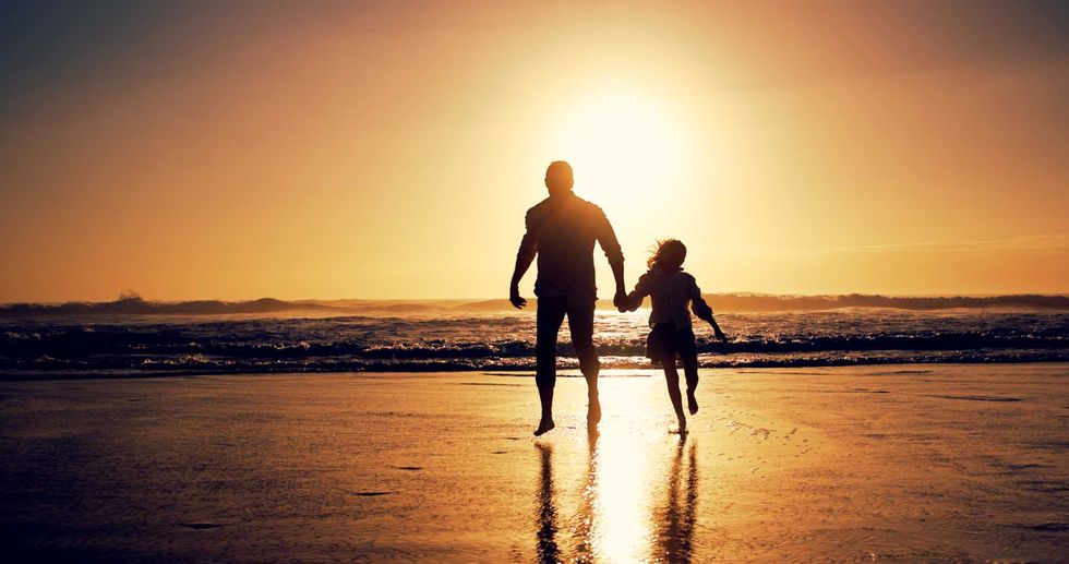 Ocean, sunset and father with girl, holding hands and travel with happiness, bonding together and wellness. Nature, beach and family with parent, daughter and dad with summer holiday and silhouette.