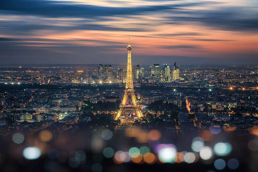 Paris city in the evening with the Eiffel tower and La Defense b