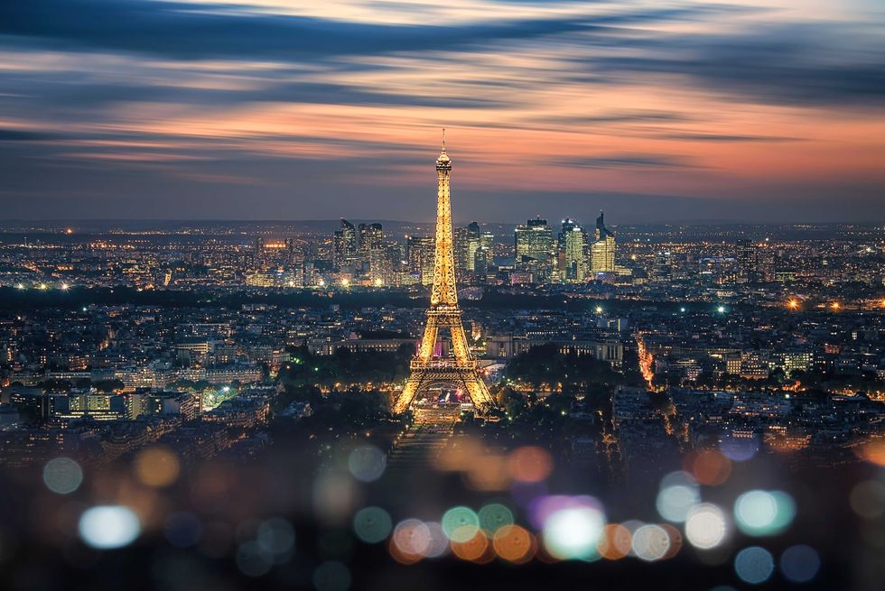 Paris city in the evening with the Eiffel tower and La Defense b