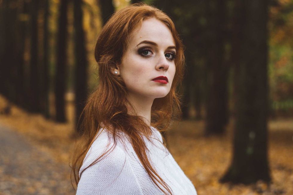 Portrait of happy beautiful redhaired girl smiling.