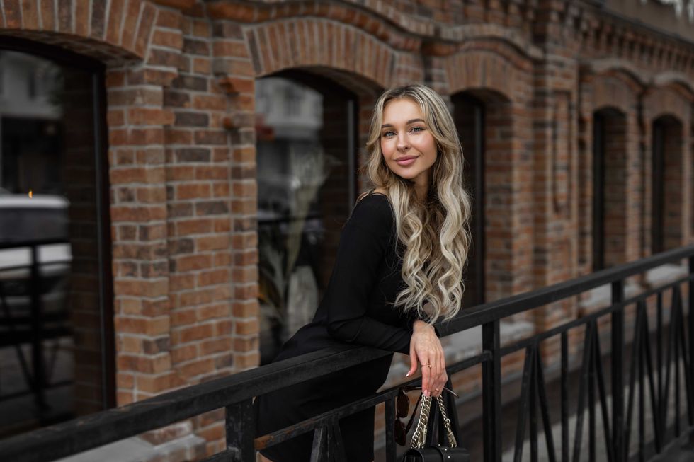 pretty blonde woman on a balcony