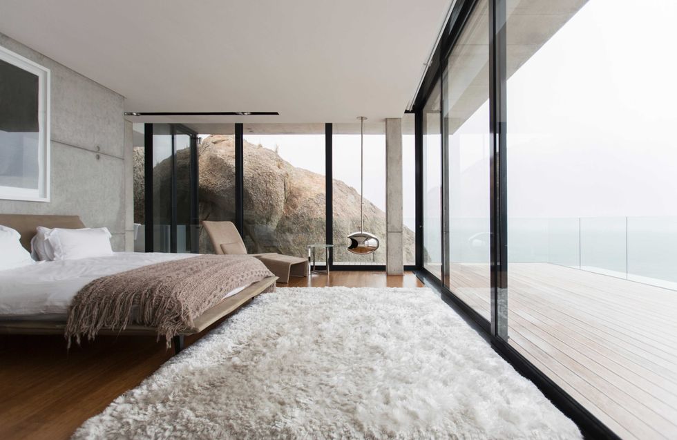 Shag rug and glass walls in modern bedroom