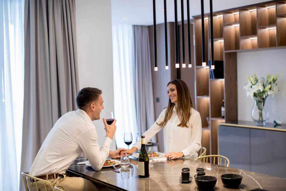 Sweet young couple having a romantic dinner at luxury kitchen