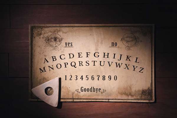 Talking board and planchette used on seances for communicating with the dead, high contrast image
