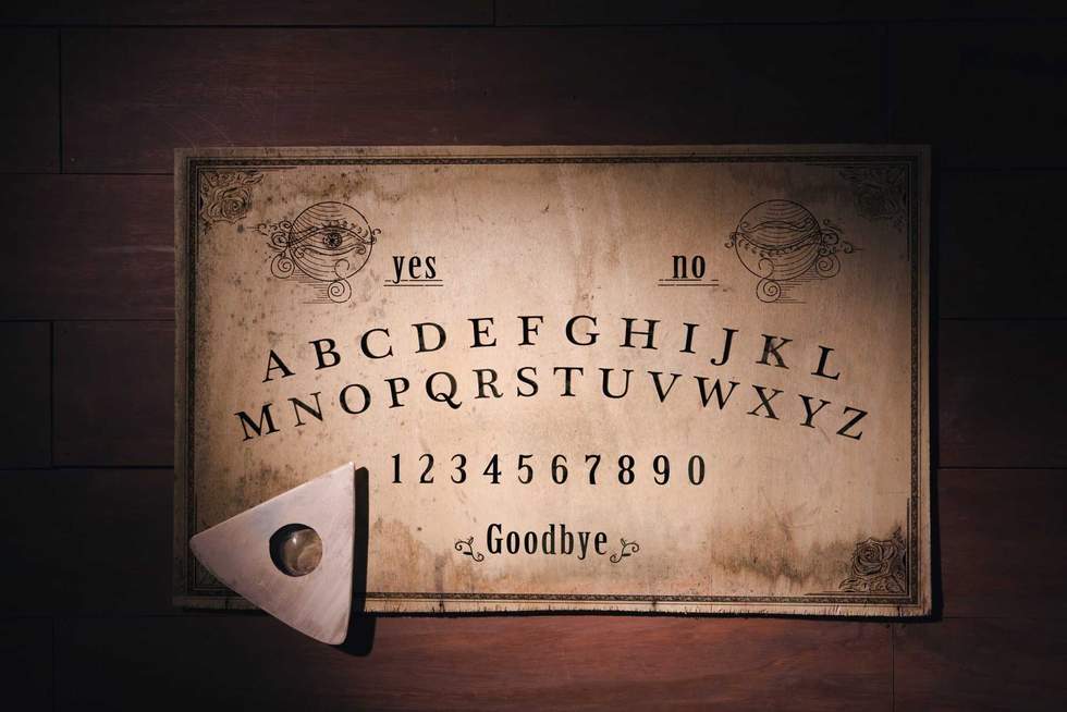 Talking board and planchette used on seances for communicating with the dead, high contrast image