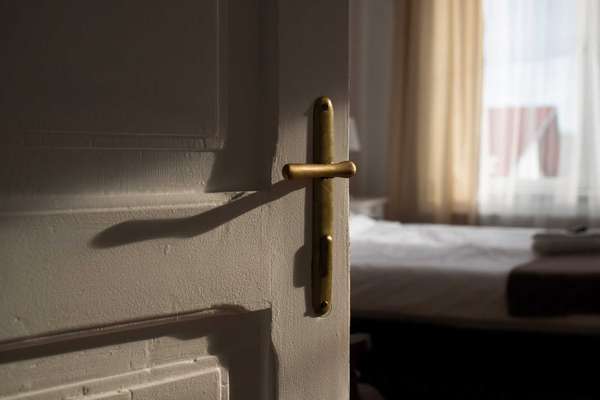 vintage white door opening into bedroom