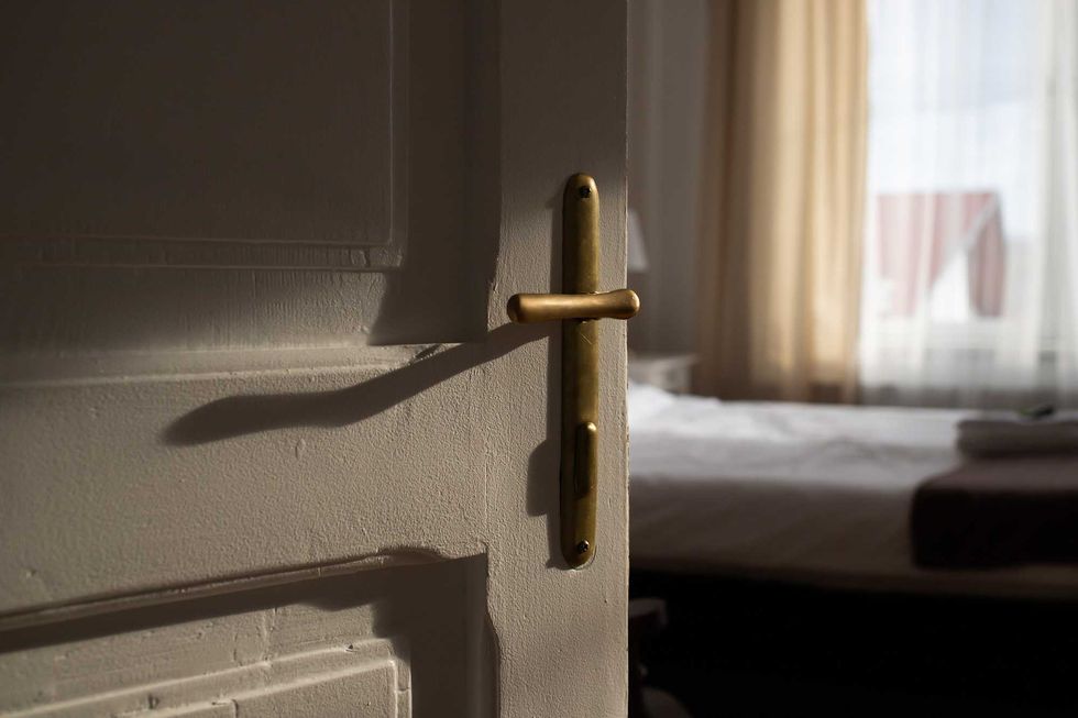vintage white door opening into bedroom
