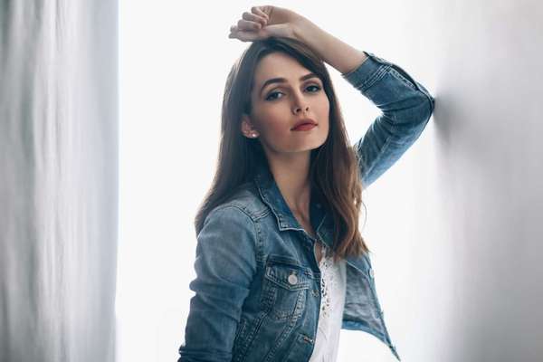 Young beautiful woman posing on white background. Fashion portrait