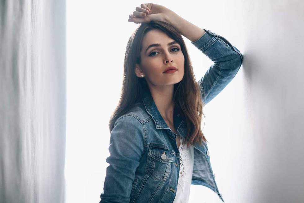 Young beautiful woman posing on white background. Fashion portrait