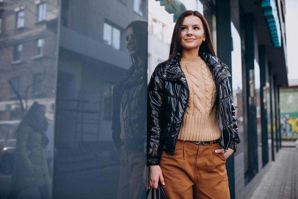 Young pretty woman in warm jacket outdoors