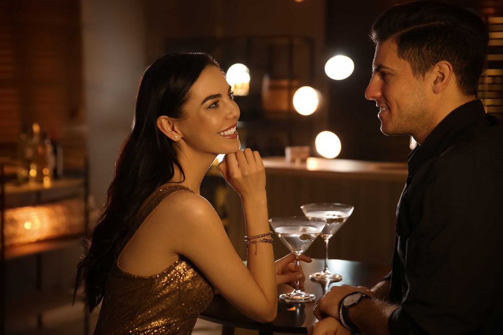 Young woman smiling at a man she's on a date with.